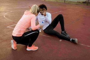 player-centric white female coach smiling with her black male mentee