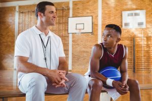 a basketball coach giving advice to his player