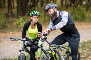 Cycling Schedule for 80 Miles Per Week - couple looking into a cycling schedule on their phone