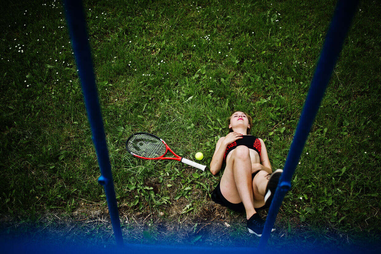 Feel Lazy If You Miss Racket Sport in the Morning - Woman lying back down feeling lazy