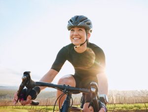 Is Cycling 70 Miles a Week Good for Weight Loss? - white woman happy while cycling