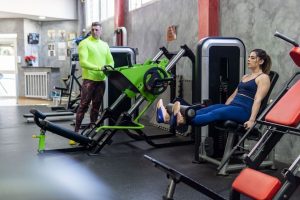 Exercise machine - lady working out at the gym