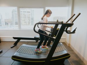 exercise machines - gym lady working out on treadmill