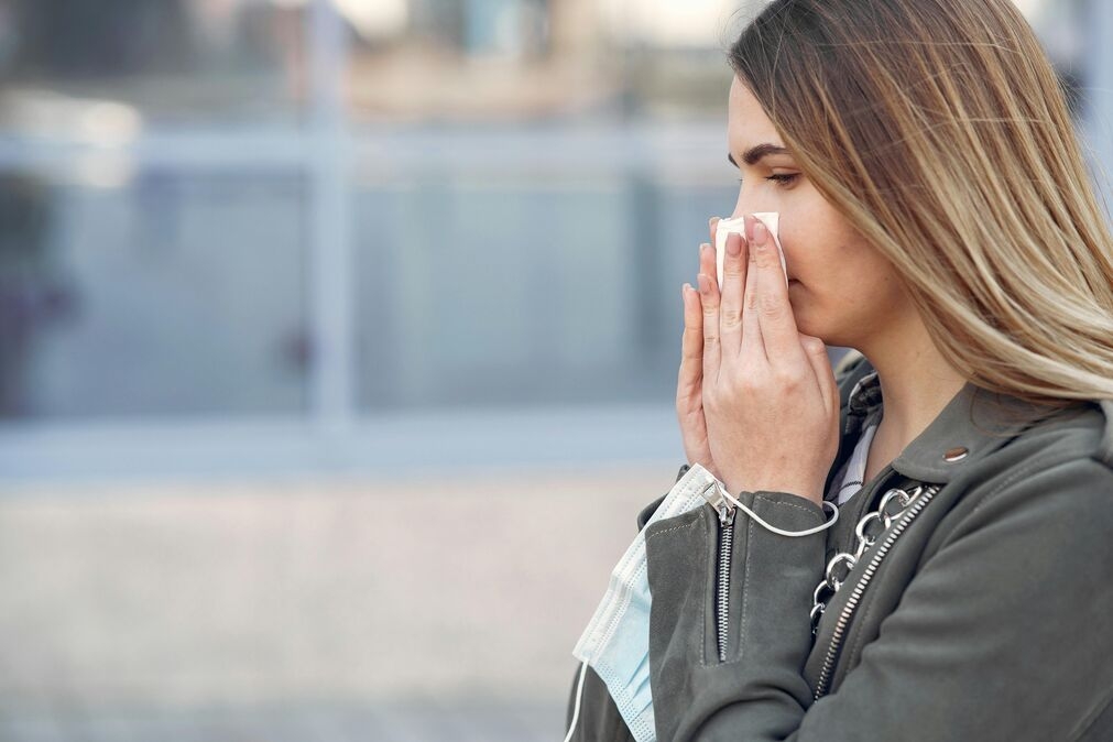 runny nose during exercise - white lady wiping her nose